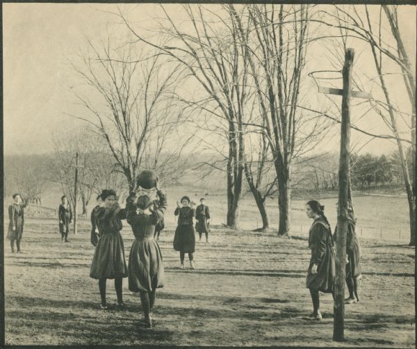 Girls play basketball outdoors at the Hillside School Wisconsin Historical Images
